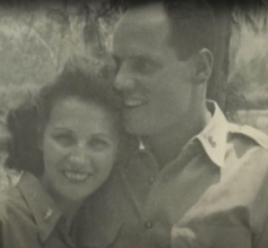 A man and a woman in uniform pose together in a black-and-white photo.