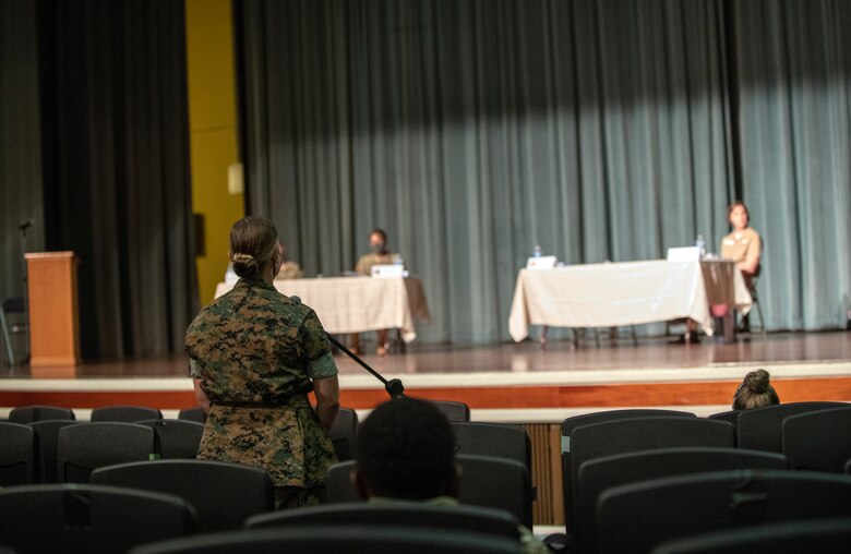 An attendee of the Women's Leadership Panel asks a question to a panel of female leaders at Kadena Air Base, Japan, Aug. 19, 2020. Women’s Equality Day acknowledged and raised awareness of the long strides the United States has taken to afford women the same allowances as men. (U.S. Air Force photo by Naoto Anazawa)