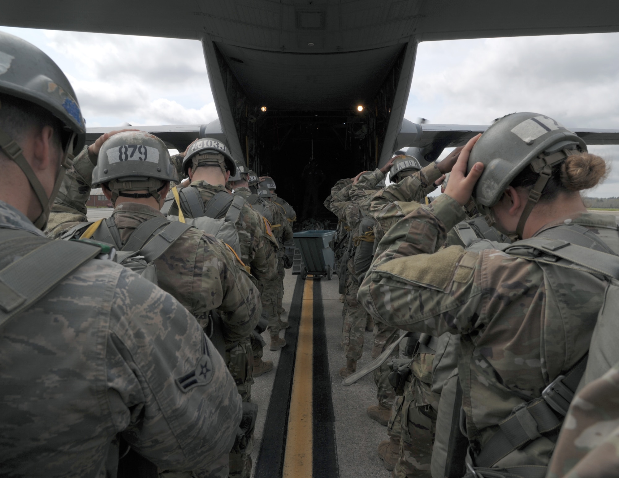 paratroopers prepare to load an aircraft