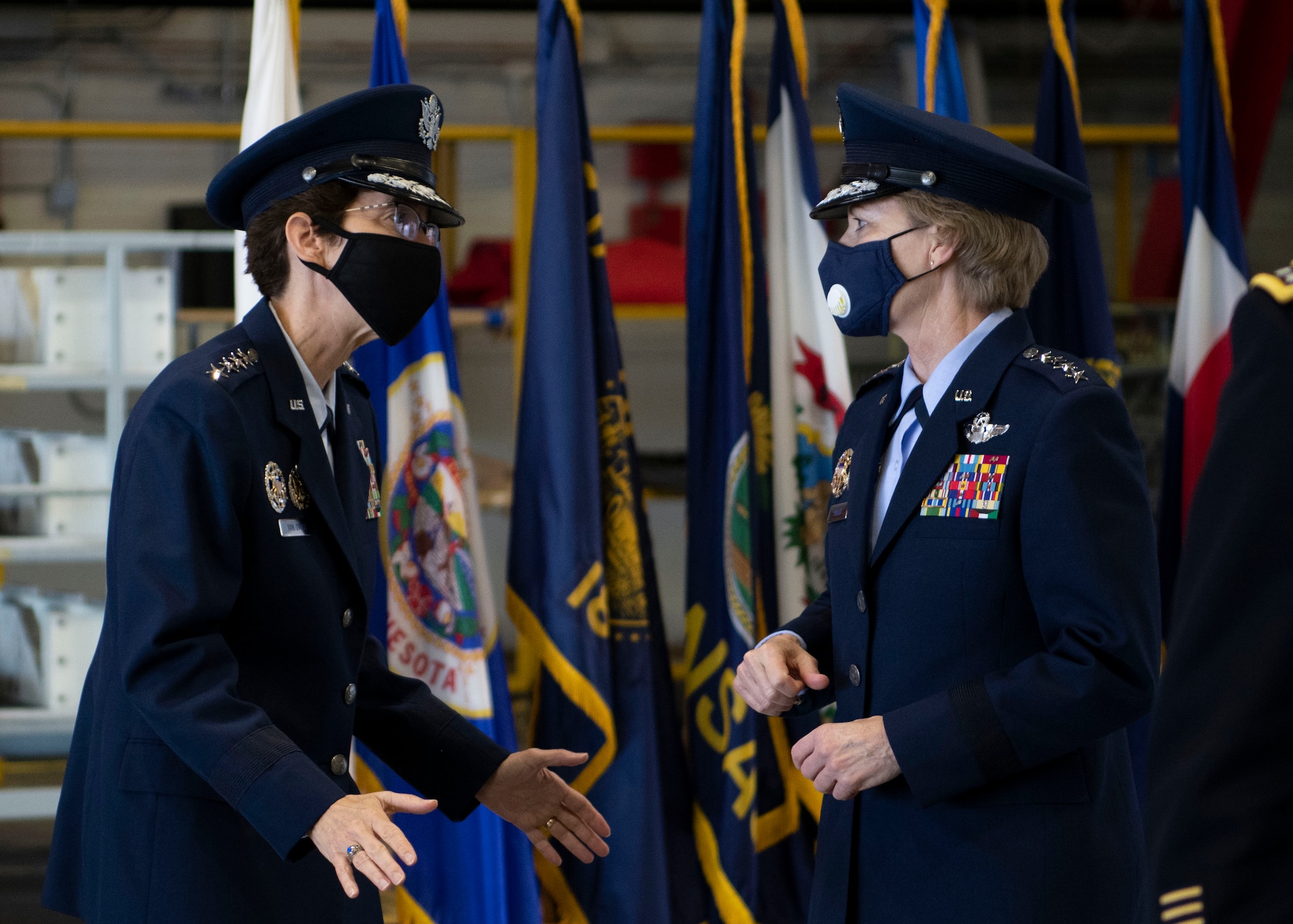 Gen. Jacqueline D. Van Ovost, incoming commander of Air Mobility Command, and Gen. Maryanne Miller, AMC commander, talk before the AMC change of command ceremony at Scott Air Force Base, Illinois, Aug. 20, 2020. Van Ovost will lead Airmen who provide airlift, aerial refueling, special air mission, aeromedical evacuation and mobility support. (U.S. Air Force photo by Senior Airman Miranda Simpson)
