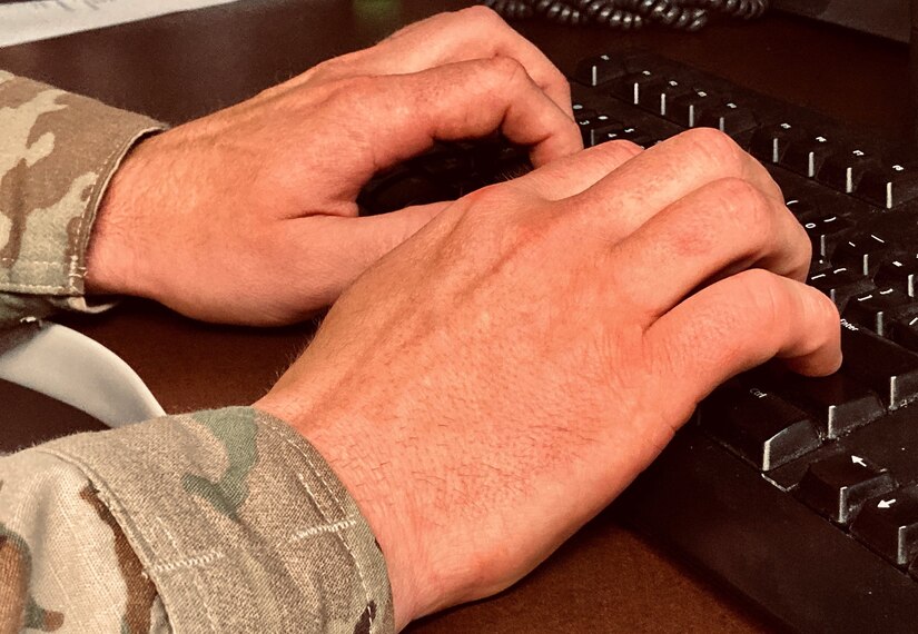 Hands on a computer keyboard.