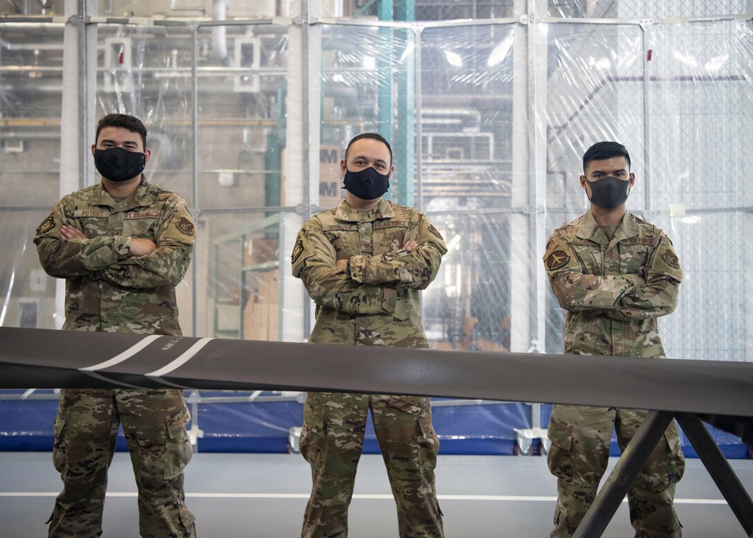 Staff Sgt. Alex Poteet (left), Aircraft Structural Maintenance Craftsman 374th Maintenance Squadron Fabrication Shop, Tech Sgt. Derek Spencer (middle), Aircraft Structural Maintenance Craftsman 374th Maintenance Squadron Fabrication Shop, and Airman 1st Class Isaiahlee Elizardo (right), Aircraft Structural Maintenance Journeyman 374th Maintenance Squadron Fabrication Shop, pose in front of the final refurbished CV-22 blade at Yokota Air Base, Japan, on August 14, 2020.