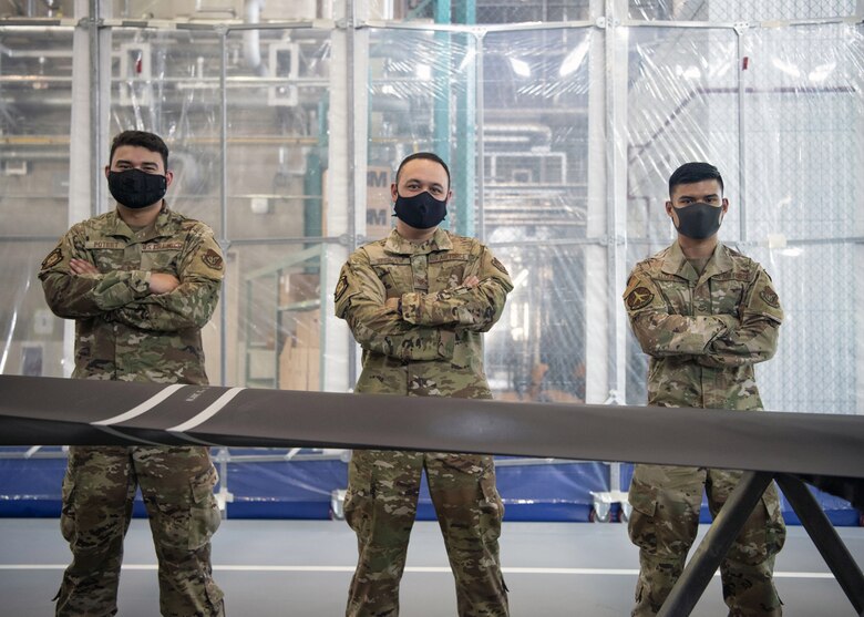 Staff Sgt. Alex Poteet (left), Aircraft Structural Maintenance Craftsman 374th Maintenance Squadron Fabrication Shop, Tech Sgt. Derek Spencer (middle), Aircraft Structural Maintenance Craftsman 374th Maintenance Squadron Fabrication Shop, and Airman 1st Class Isaiahlee Elizardo (right), Aircraft Structural Maintenance Journeyman 374th Maintenance Squadron Fabrication Shop, pose in front of the final refurbished CV-22 blade at Yokota Air Base, Japan, on August 14, 2020.