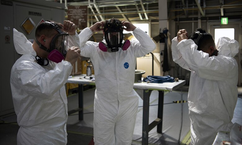 Tech Sgt. Derek Spencer (left), Aircraft Structural Maintenance Craftsman 374th Maintenance Squadron Fabrication Shop, Staff Sgt. Alex Poteet (middle), Aircraft Structural Maintenance Craftsman 374th Maintenance Squadron Fabrication Shop, and Airman 1st Class Isaiahlee Elizardo (right), Aircraft Structural Maintenance Journeyman 374th Maintenance Squadron Fabrication Shop, finish putting on Personal Protective Equipment before applying paint primer to a CV-22 blade at Yokota Air Base Japan, August 12, 2020.
