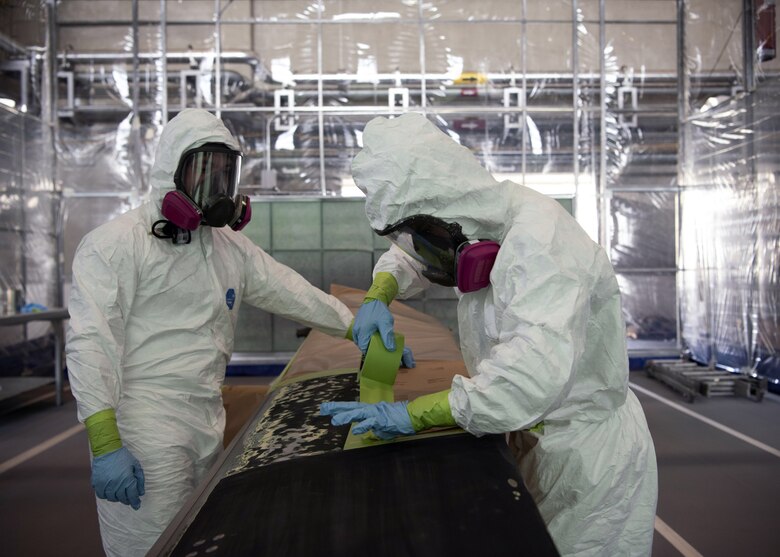 ech. Sgt. Derek Spencer (left), Aircraft Structural Maintenance Craftsman 374th Maintenance Squadron Fabrication Shop, and Airman 1st Class Isaiahlee Elizardo (right), Aircraft Structural Maintenance Journeyman 374th Maintenance Squadron Fabrication Shop,  prepare a CV-22 blade for paint primer at Yokota Air Base, Japan, August 12, 2020.