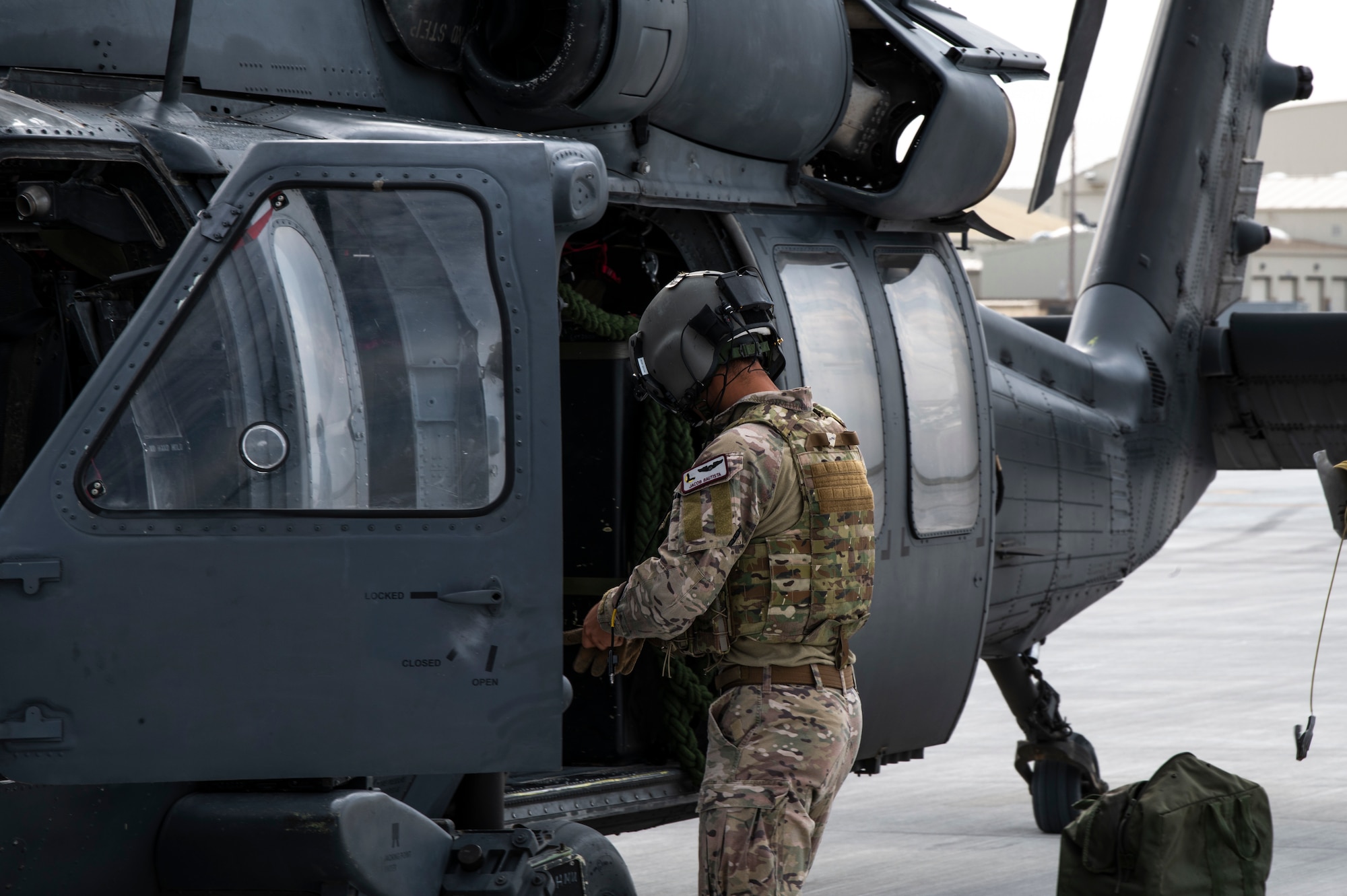 An aircrewmember of an U.S. Air Force HH-60G Pave Hawk from the 55th Rescue Squadron puts on gloves in preparation for a simulated rescue mission, Aug. 17, 2020, at Mountain Home Air Force Base, Idaho. The 55th RQS is participating in Gunfighter Flag 20-1, where it trains with joint and international partners to complete combat and rescue exercises. (U.S. Air Force photo by Airman 1st Class Andrew Kobialka)