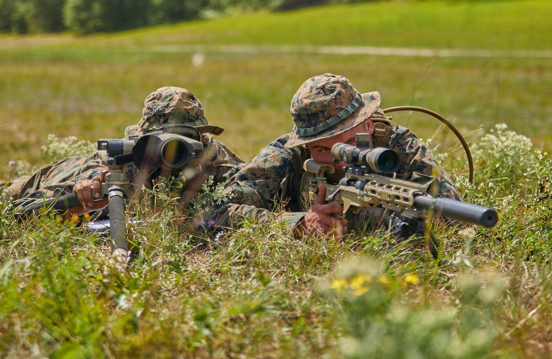 Sgt. Parker Wilkinson, a squad leader with Bravo Company, 1st Battalion, 24th Marine Regiment, 4th Marine Division, provides the course of action to his team members through a model of their upcoming range during their annual training exercise on Camp Grayling, Mich., Aug. 17, 2020. The training and readiness manual gives guidance on the equipment, ammunition, ranges and support requirements to plan and execute effective training to increase Marines’ lethality. (U.S. Marine Corps photo by Lance Cpl. Leslie Alcaraz)