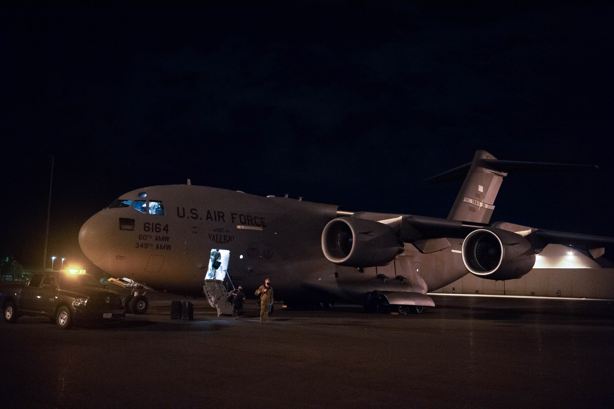 A C-17 Globemaster III air crew from Travis Air Force Base, Calif., disembarks on the McChord Field flightline at Joint Base Lewis-McChord, Wash., Aug. 20, 2020. Four C-17s from Travis AFB evacuated to JBLM after the Travis AFB installation commander ordered an emergency evacuation of non-mission essential personnel due to fires near Fairfield and Vacaville, Calif. (U.S. Air Force photo by Senior Airman Sara Hoerichs)