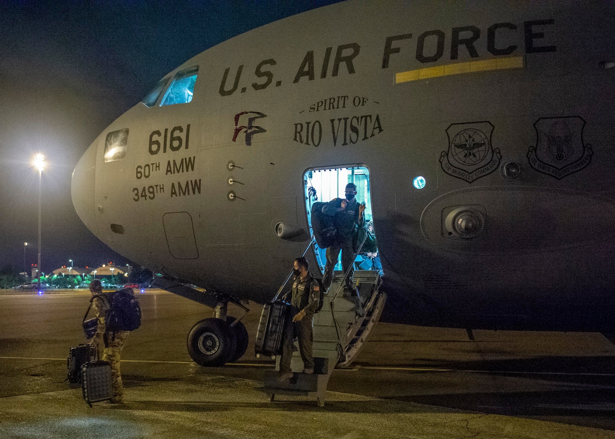 A C-17 Globemaster III air crew from Travis Air Force Base, Calif., disembarks on the McChord Field flightline, Joint Base Lewis-McChord, Wash., Aug. 20, 2020. Airmen from Team McChord coordinated arrival and transportation for air crews of four Travis AFB C-17s after they evacuated due to fires near Fairfield and Vacaville, Calif. (U.S. Air Force photo by Senior Airman Sara Hoerichs)