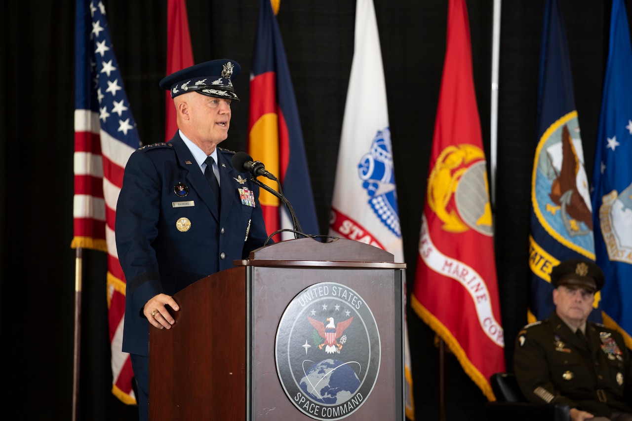 A man in military uniform speaks at a podium.