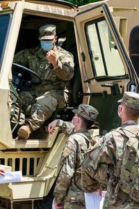 Spc. Jesse Fugate, a mechanic assigned to India Company, 429th Brigade Sustainment Battalion, teaches Soldiers from 1st Battalion, 149th Infantry, about preventive maintenance checks and services on a light utility truck at Harold L. Disney Training Center, Artemus, Ky., July 30, 2020.