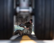 Staff Sgt. Brandon Whitley, an aerospace mechanic assigned to the 437th Aircraft Maintenance Squadron, connects an anti-collision light to the bottom of a C-17 Globemaster III at Joint Base Charleston, S.C., Aug. 18, 2020. The 437th AMXS inspects, services, and maintains the assigned C-17 aircraft at Joint Base Charleston.