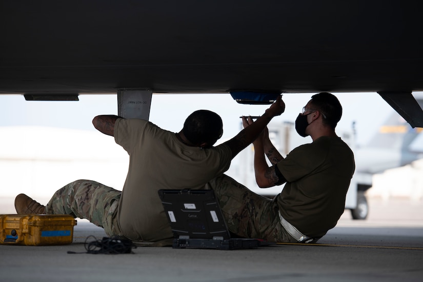 Tech. Sgt. Joie Lucas and Staff Sgt. Brandon Whitley, aerospace mechanics assigned to the 437th Aircraft Maintenance Squadron, install an anti-collision light to the bottom of a C-17 Globemaster III at Joint Base Charleston, S.C., Aug. 18, 2020. The 437th AMXS inspects, services, and maintains the assigned C-17 aircraft at Joint Base Charleston.