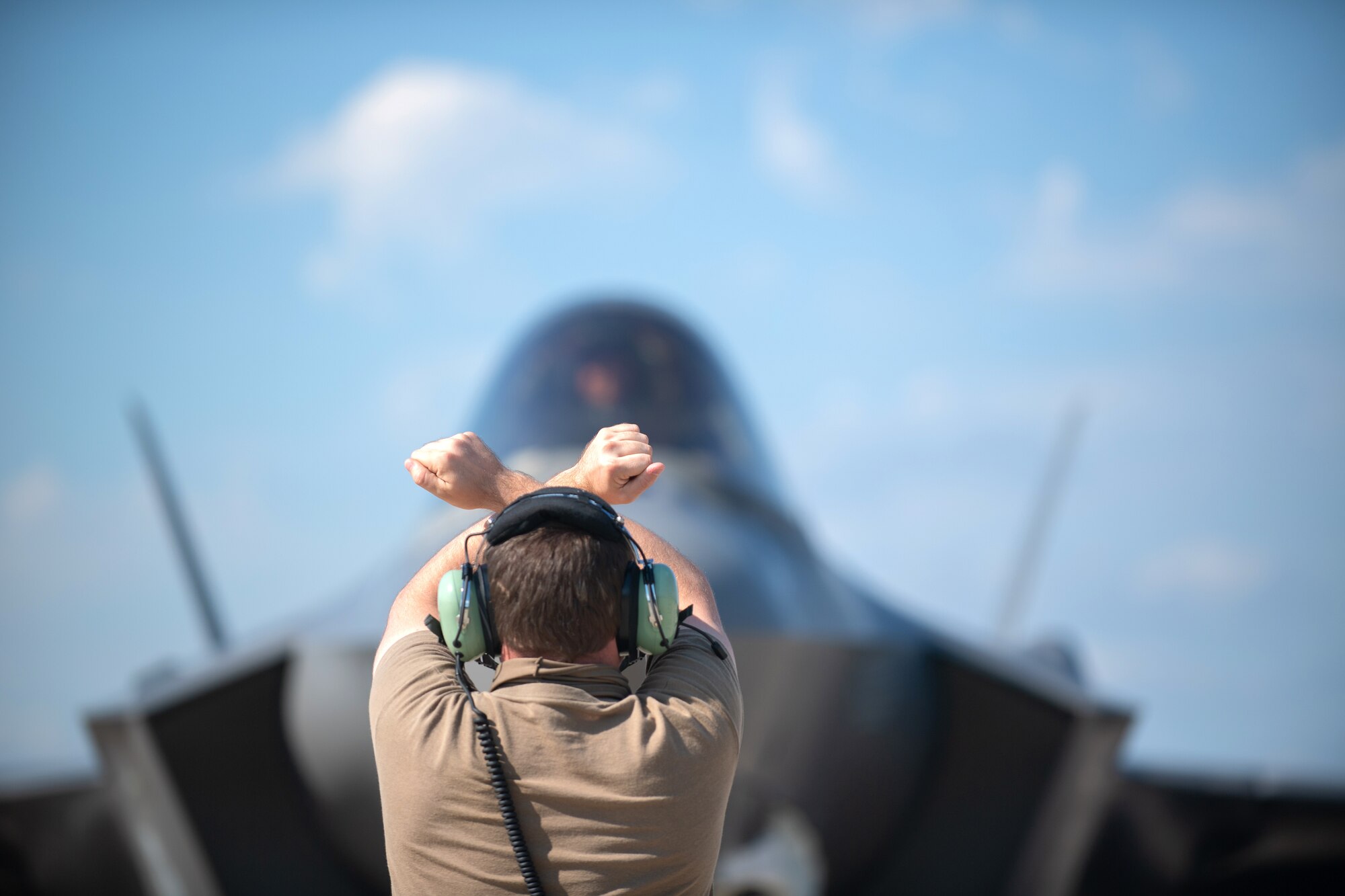 A crew chief assigned to the 158th Maintenance Group, Vermont Air National Guard, marshals an F-35A Lightning II at Northern Lightning, a training exercise held annually at Volk Field, Wisc., Aug. 13, 2020. Lt. Col. John “Rocky” MacRae, assigned to the 134th Fighter Squadron, Vermont Air National Guard, was piloting this Tail 5279, which achieved the thousandth sortie milestone for the Green Mountain Boys. (U.S. Air National Guard photo by Ms. Julie M. Shea)