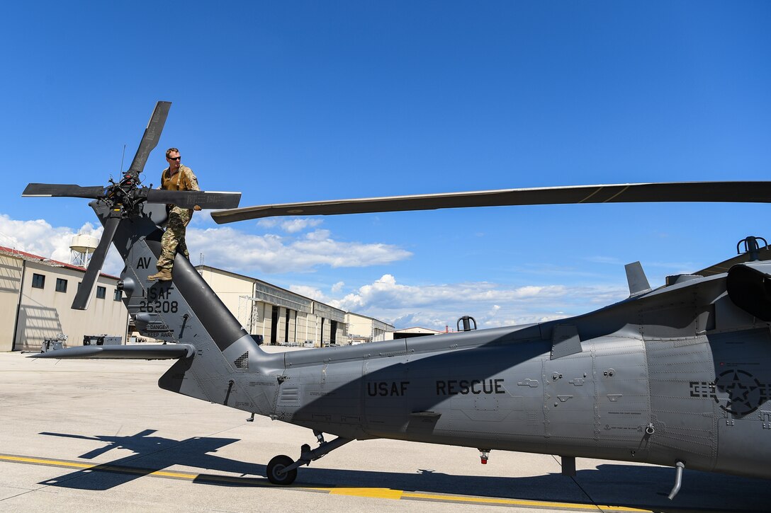 U.S. Air Force Master Sgt. Steven Prather, a 56th Rescue Squadron flight chief, performs a preflight check on an HH-60G Pave Hawk helicopter before going on a training exercise to Croatia at Aviano Air Base, Italy, Aug. 19, 2020. The 56th RQS offers long-range rescue, humanitarian assistance, non-combatant evacuation and disaster relief capabilities for USEUCOM, USAFRICOM and NATO in peacetime, contingency and wartime operations. The primary mission of the HH-60G is to conduct day or night personnel recovery operations into hostile environments to recover isolated personnel. (U.S. Air Force photo by Airman 1st Class Thomas S. Keisler IV)