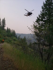 The Idaho Army National Guard Aviation Group helped rescue an injured man on a mountainside about 20 miles east of Idaho City Aug. 20, 2020, hoisting him to safety in a UH-72 Lakota helicopter. The 55-year-old man spent the night on the side of a mountain after rolling his all-terrain vehicle down a steep embankment.