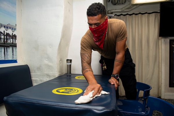 Retail Services Specialist Seaman Peni Tovehi, from Fiji, wipes down tables on the mess decks aboard the Arleigh Burke-class guided-missile destroyer USS Sterett (DDG 104).