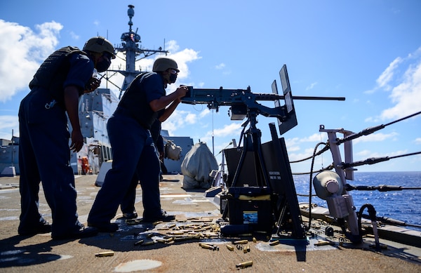 Gunner's Mate Seaman Apprentice Isaiah Moore, from Las Vegas, fires a .50-caliber machine gun aboard the Arleigh Burke-class guided-missile destroyer USS Chung-Hoon (DDG 93)