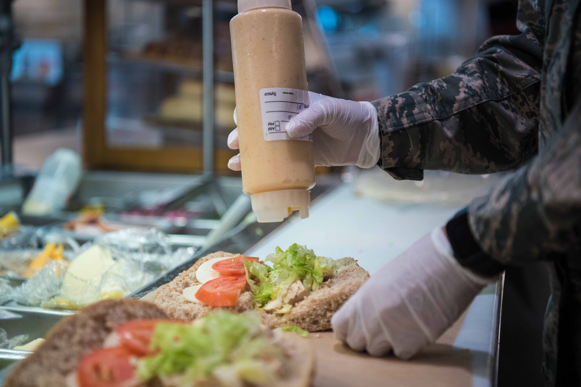 Airman 1st Class Farrin Santana, 931st Force Support Squadron food service apprentice, prepares meals during the Operational Readiness Inspection Aug. 19, 2020, at McConnell Air Force Base, Kansas. The 22nd FSS dining facility team packaged 32 boxed lunches and served hot meals throughout the day. (U.S. Air Force photo by Senior Airman Alexi Bosarge)