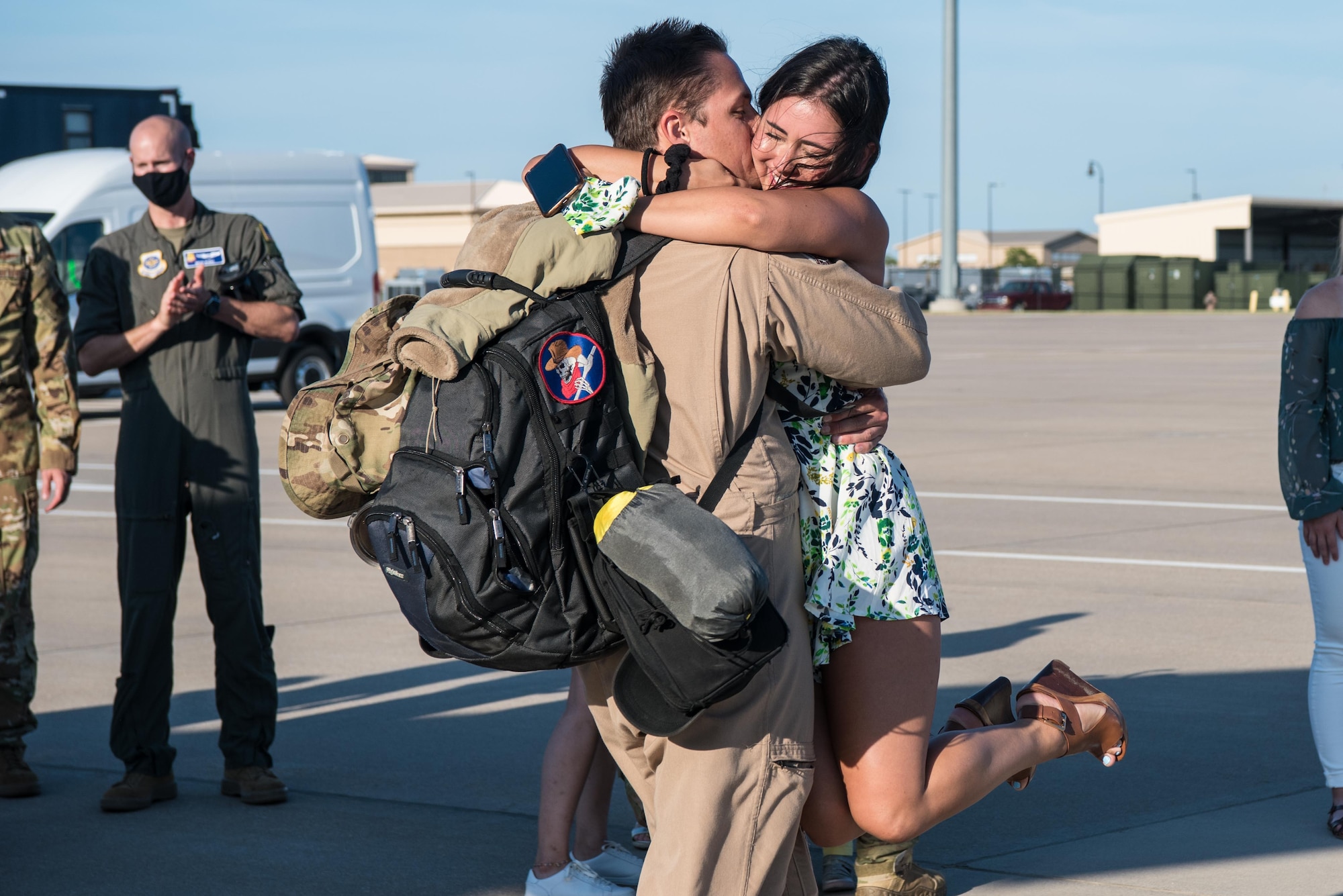 Capt. Collin Tuthill, 349th Air Refueling Squadron pilot, hugs his girlfriend, Erika Black, after returning home from a deployment to Southwest Asia, Aug. 20, 2020, at McConnell Air Force Base, Kansas. Tuthill and the rest of the team delivered more than 38 million pounds of fuel to 16 different airframes during the deployment. (U.S. Air Force photo by Senior Airman Alexi Bosarge)