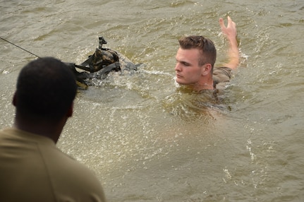 Spc. Braxton Todd, a Virginia National Guard Soldier assigned to the Fort Belvoir-based Headquarters Battalion, 29th Infantry Division, completes the water combat survival test during Day 3 of the Region II Best Warrior Competition, July 30, 2020, at Edgewood Area Aberdeen Proving Ground, Maryland. (U.S. National Guard photo by A.J. Coyne)