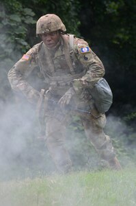 Staff Sgt. Eddie Jones, a Virginia National Guard Soldier assigned to the Fort Belvoir-based Headquarters Battalion, 29th Infantry Division, reacts to indirect fire during the Army Warrior Task portion of Day 1 of the Region II Best Warrior Competition, July 28, 2020, at H Steven Blum Military Reservation in Glen Arm, Maryland. (U.S. National Guard photo by A.J. Coyne)