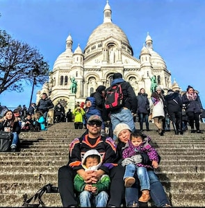 Family of four sits on steps