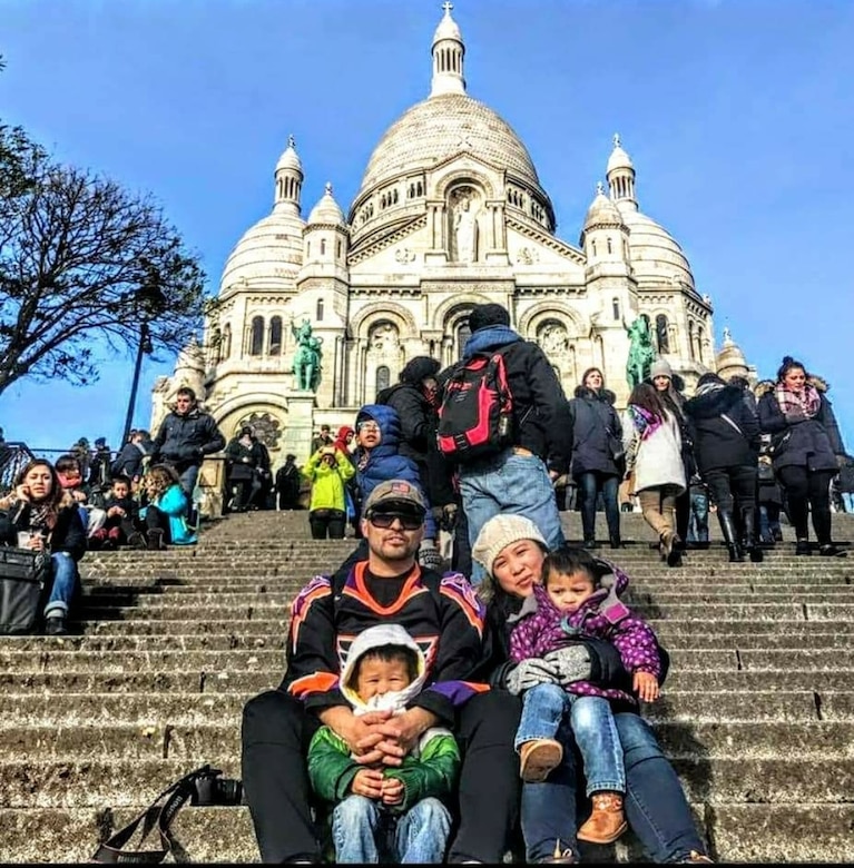 Family of four sits on steps