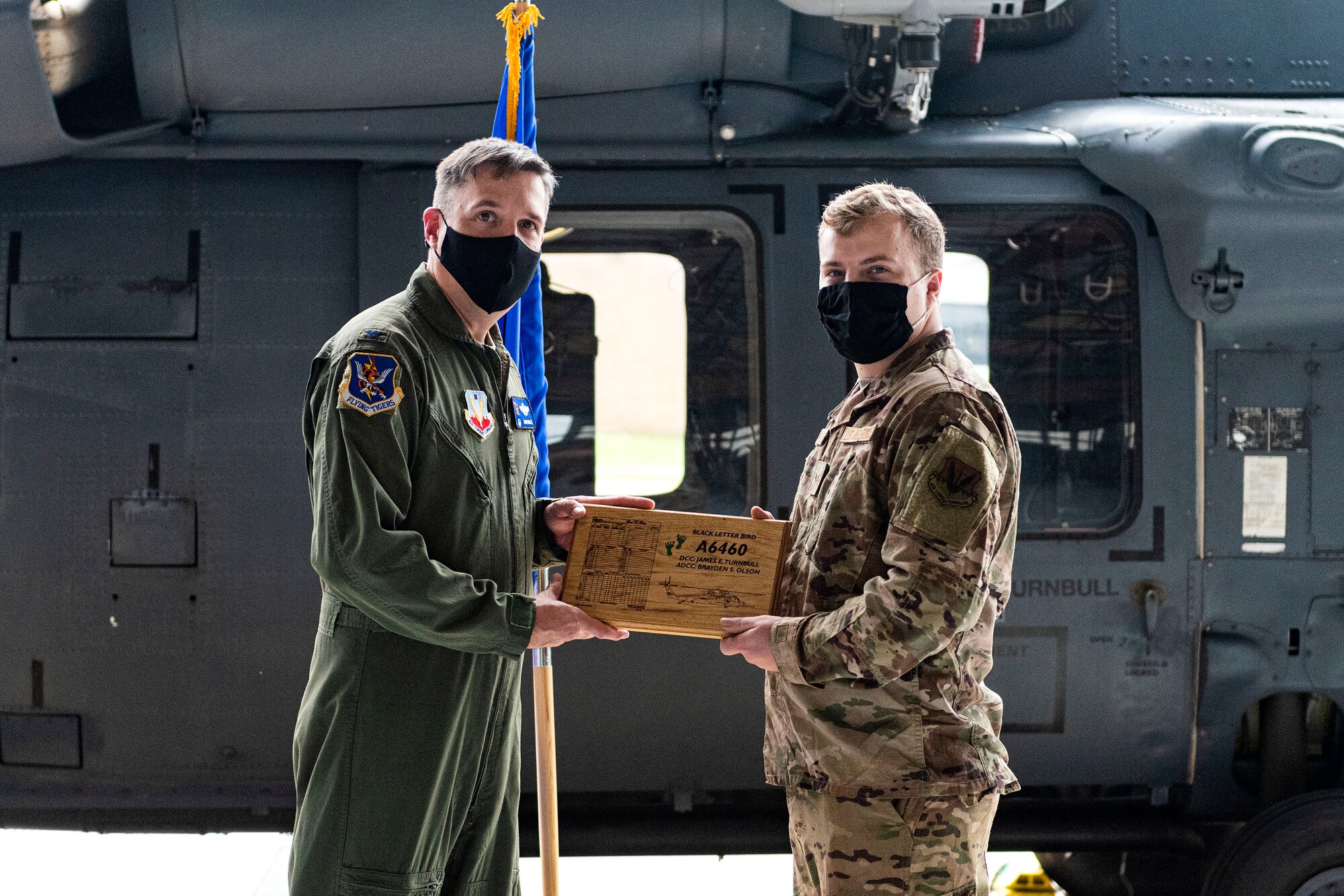 Photo of wing commander posing for a photo with an Airman.