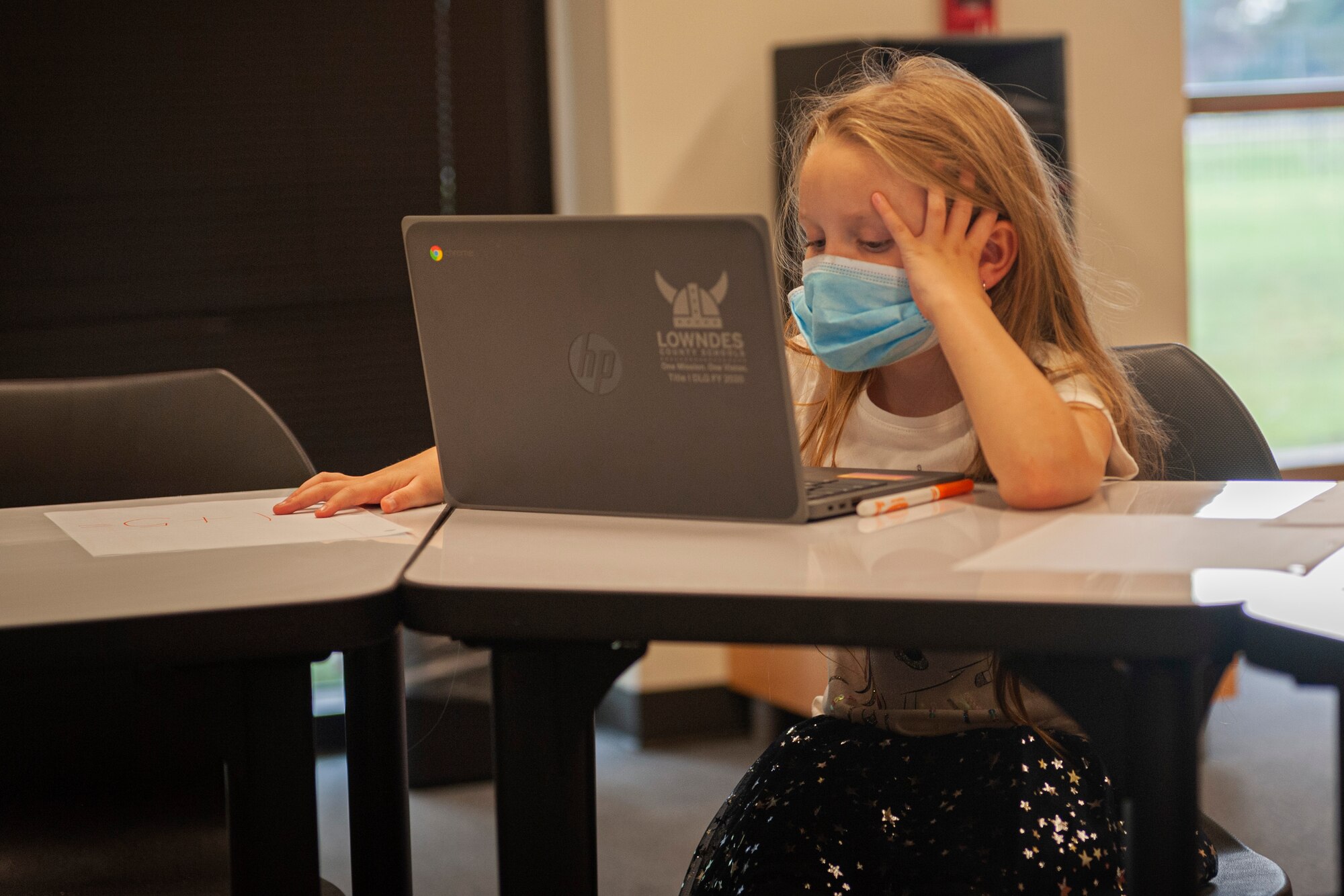 Photo of a kid completing virtual classwork