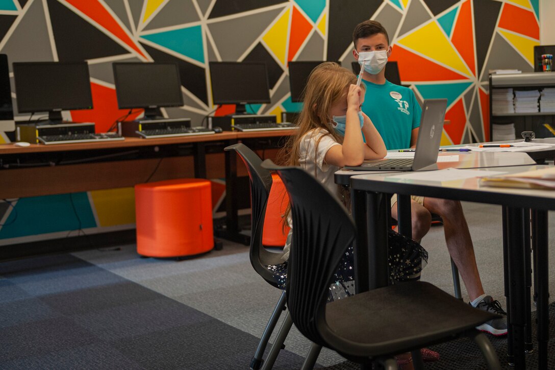 Photo of a Youth Center staff member supervising a kid