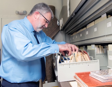 Lane Bourgeois, 12th Flying Training Wing historian, sifts through a pile of historical documents in his office at Joint Base San Antonio-Randolph June 12, 2019.