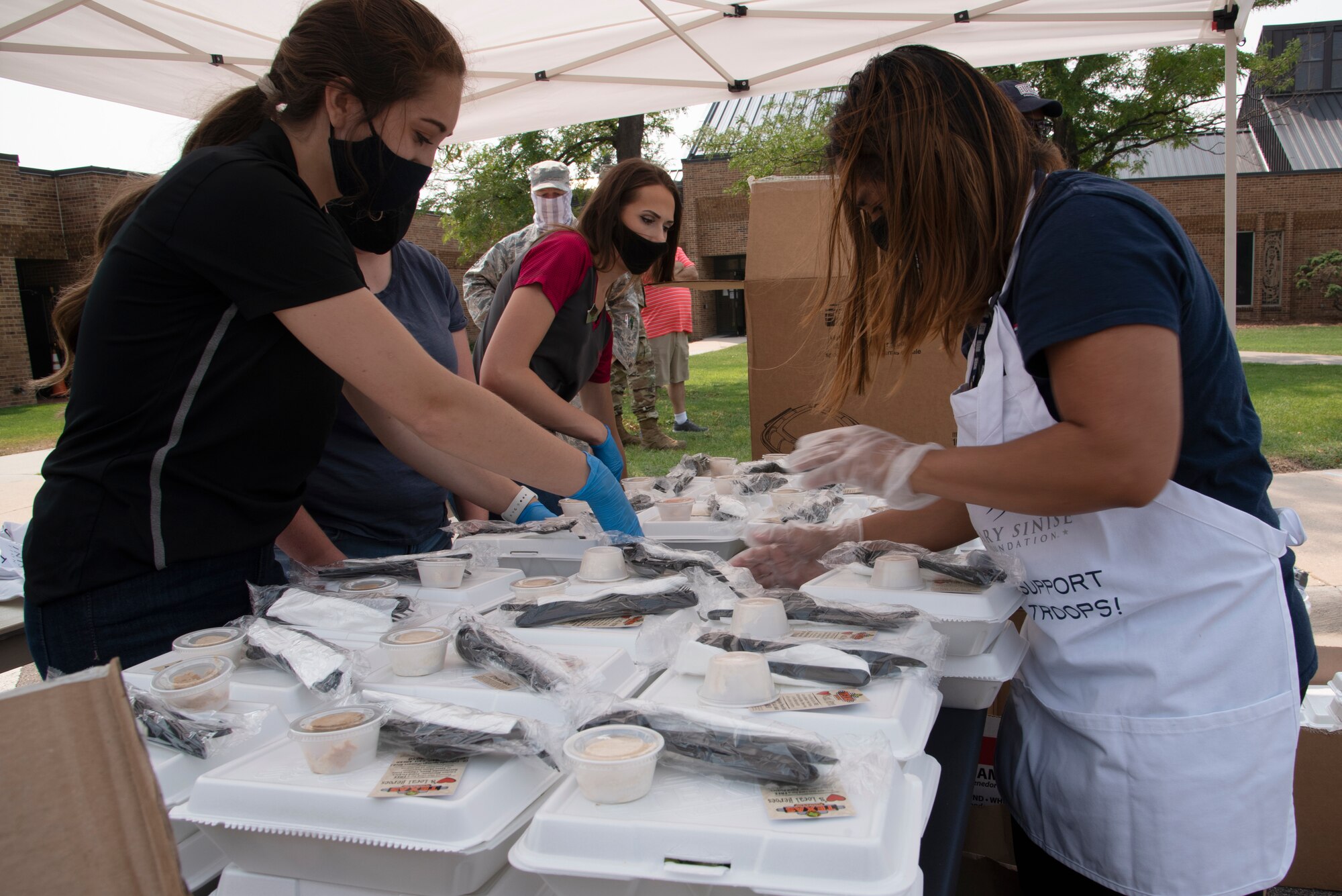 Volunteers serving boxed lunches