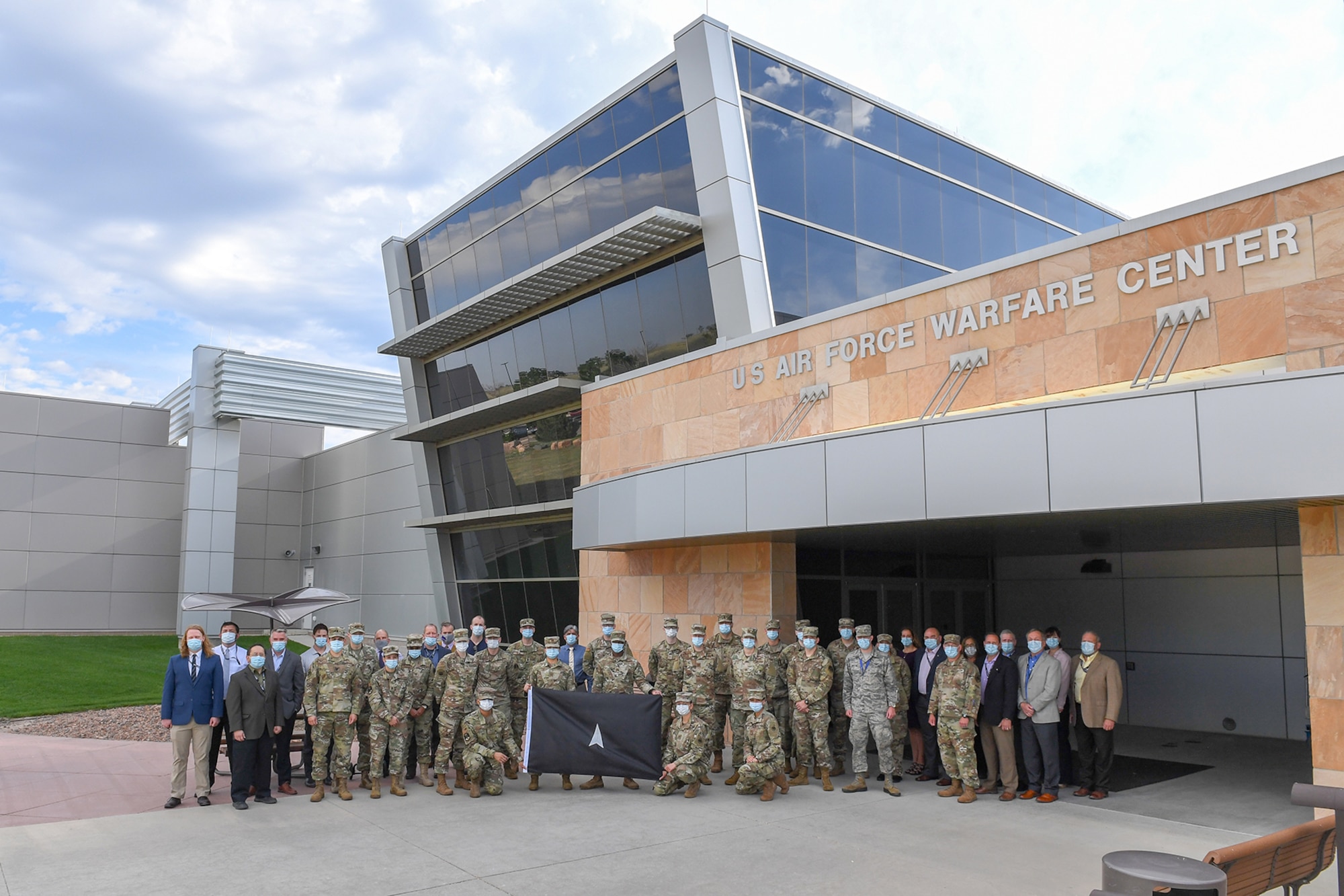Space Flag 20-3 participants stand in front of the U.S. Air Force Warfare Center at Schriever Air Force Base, Colorado. This was the first Space Flag exercise completed as part of the new Space Training and Readiness