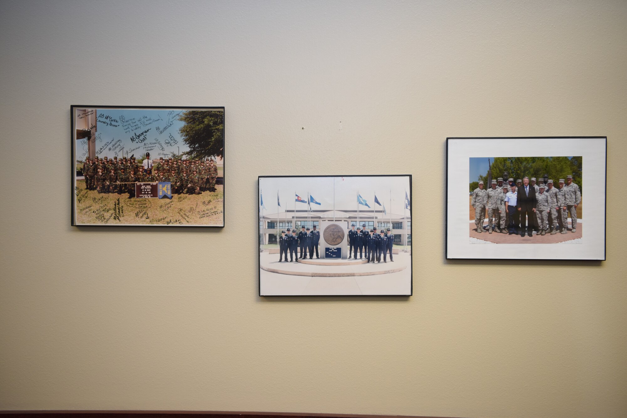 Photos from U.S. Air Force Chief Master Sgt. Casy Boomershine, 17th Training Wing command chief’s past are mounted to the wall in the Norma Brown building on Goodfellow Air Force Base, Texas, Aug. 5, 2020. Boomershine’s walls are full of her achievements, hobbies, and relics of her life and career. (U.S. Air Force photo by Airman 1st Class Ethan Sherwood)