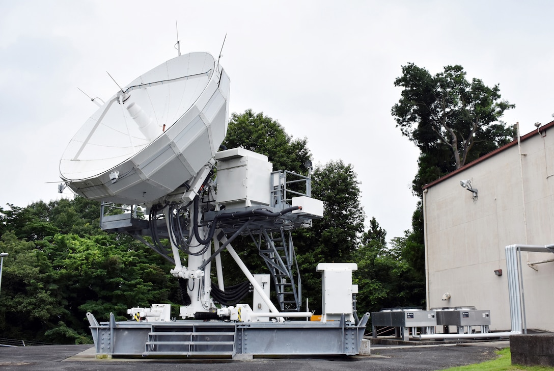 A satellite terminal stands outside a building.