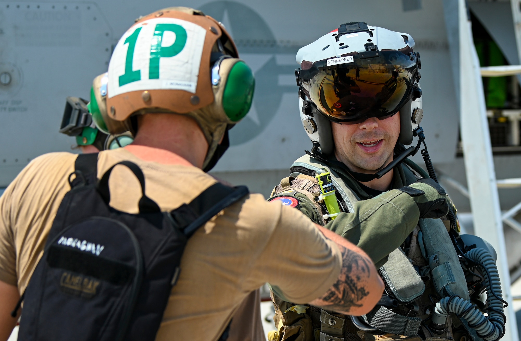 Sailor greets pilot on the flight line.