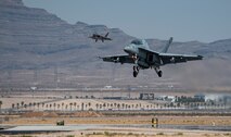 Aircraft lands on flight line.