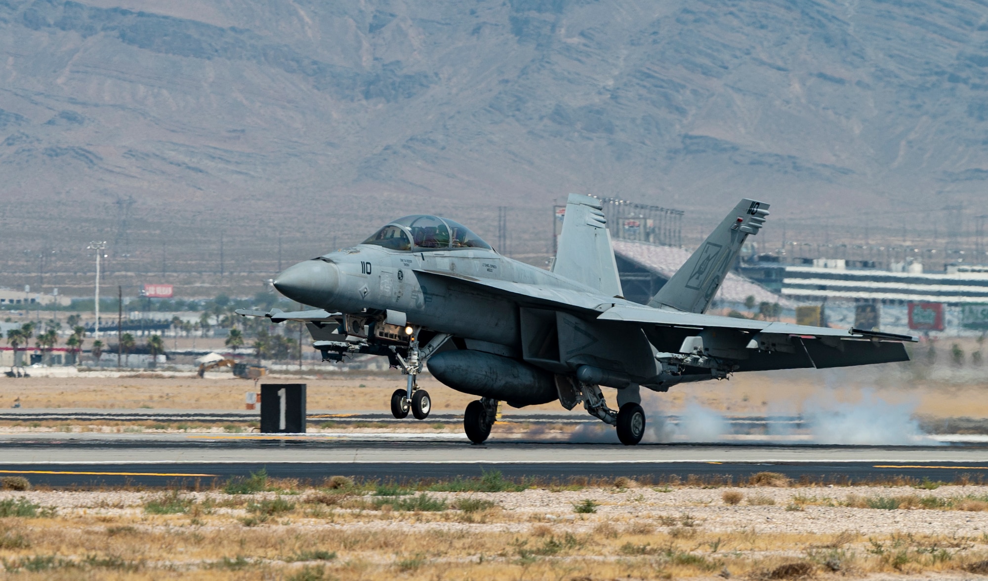 Aircraft lands on flight line.