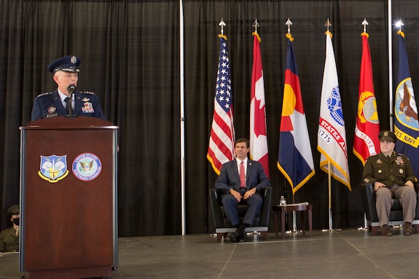 A military officer speaks from behind a dias.