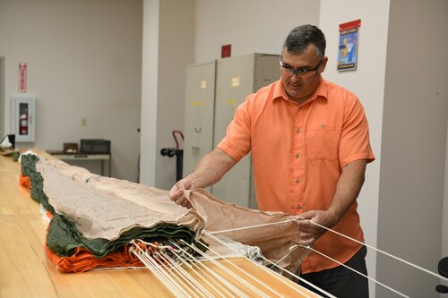 Technician inspecting parachute