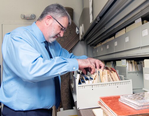 Lane Bourgeois, 12th Flying Training Wing historian, sifts through a pile of historical documents in his office at Joint Base San Antonio-Randolph June 12, 2019.