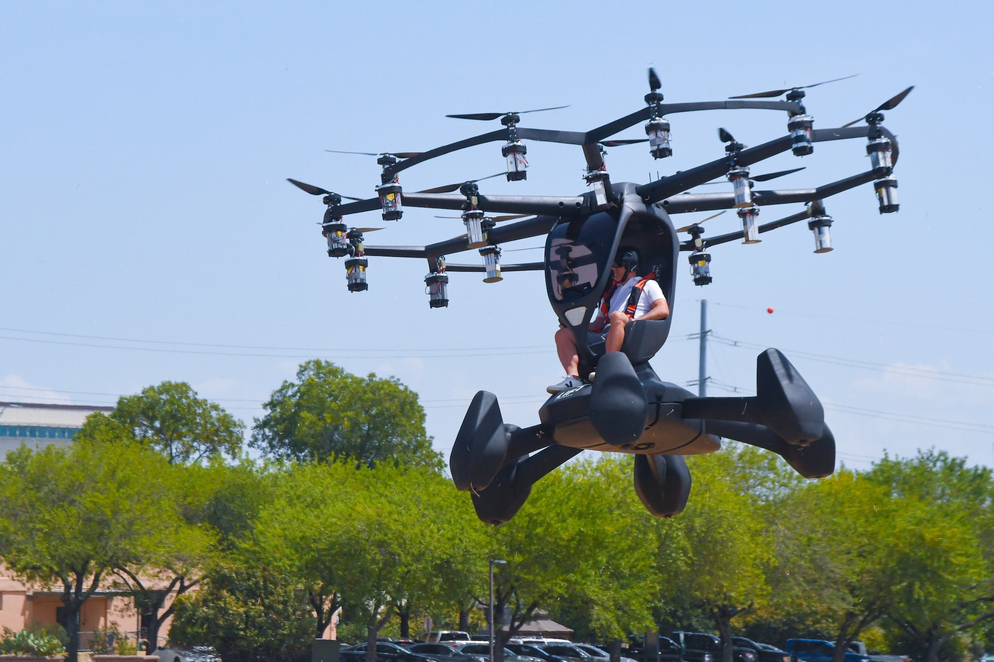 Matt Chasen, LIFT Aircraft chief executive officer, pilots the electric vertical takeoff and landing (eVTOL) Hexa over Camp Mabry, Texas, Aug. 20, 2020. During the visit, Col. Nathan Diller, AFWERX director, spoke about Agility Prime, a non-traditional program seeking to accelerate the commercial market for advanced air mobility vehicles. (Air National Guard photo by Staff. Sgt. Sean Kornegay)