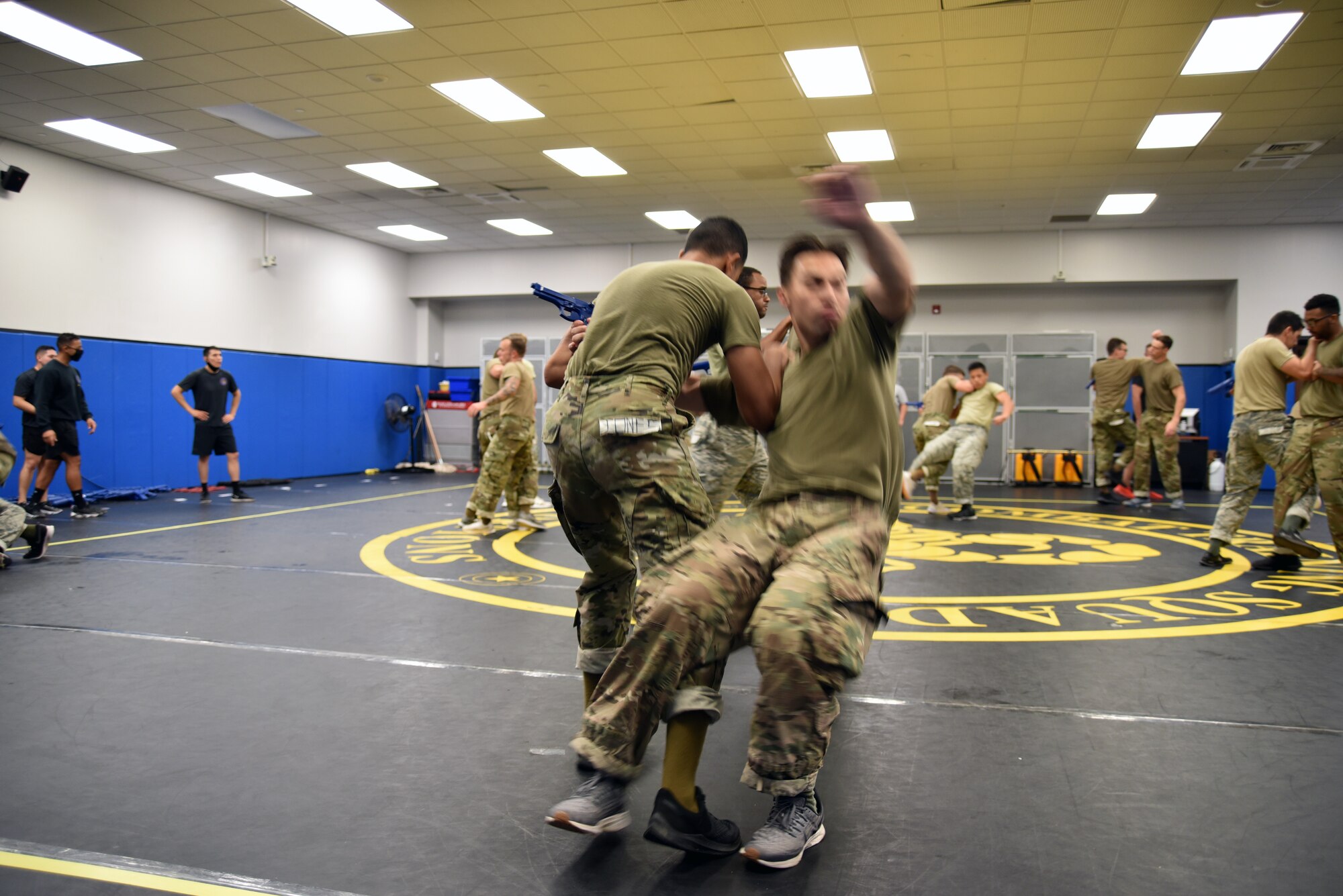 Airman Marcus Sanchez, 60th Security Forces Squadron, sweeps the leg out from under his training partner, Airman Austin Seiffert, 87th Security Forces Squadron, to take him down and disarm him during the Phoenix Rave Qualification Course at the U.S. Air Force Expeditionary Center, Aug. 14, 2020, at JB MDL. The course, which ran from July 27 to Aug, 19, qualifies selected security forces personnel to perform as members of a force protection team assigned to deploy with Department of Defense aircraft to austere environments. Students are trained to perform as teams to detect, deter, and counter threats to personnel/aircraft at deployed locations by performing close-in aircraft security and advising aircrew on force protection measures. In addition, the course prepares students to conduct/report airfield assessments and perform flight deck denial duties on select missions. (U.S. Air Force photo by Maj. George Tobias)