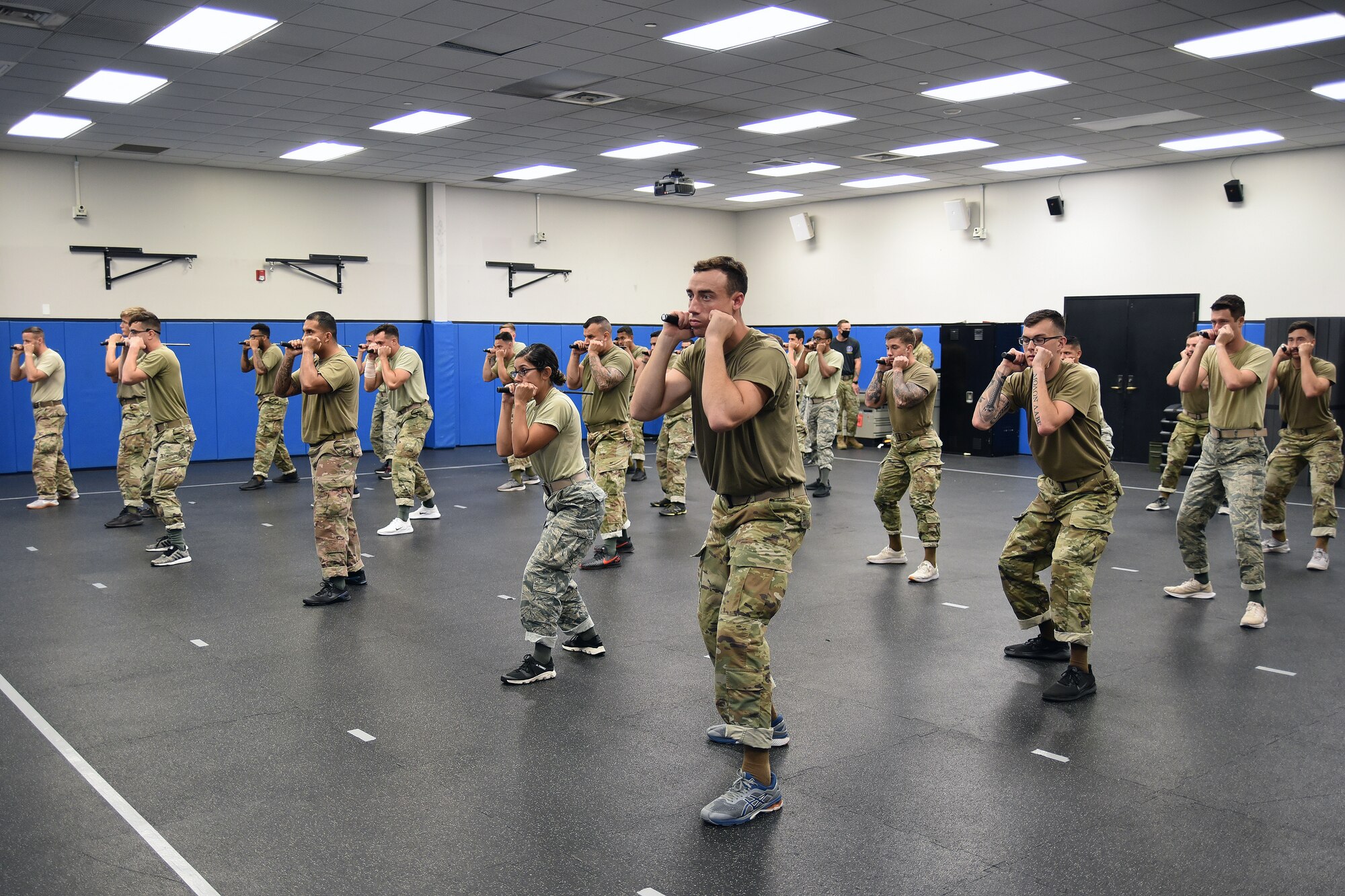 Phoenix Rave Qualification Course students practice extending the Armament Systems and Procedures baton and getting into a defensive position ready to strike during the Phoenix Rave Qualification Course at the U.S. Air Force Expeditionary Center, Aug. 14, 2020, at Joint Base McGuire-Dix-Lakehurst, New Jersey. The course, which ran from July 27 to Aug, 19, qualifies selected security forces personnel to perform as members of a force protection team assigned to deploy with Department of Defense aircraft to austere environments. Students are trained to perform as teams to detect, deter, and counter threats to personnel/aircraft at deployed locations by performing close-in aircraft security and advising aircrew on force protection measures. In addition, the course prepares students to conduct/report airfield assessments and perform flight deck denial duties on select missions. (U.S. Air Force photo by Maj. George Tobias)