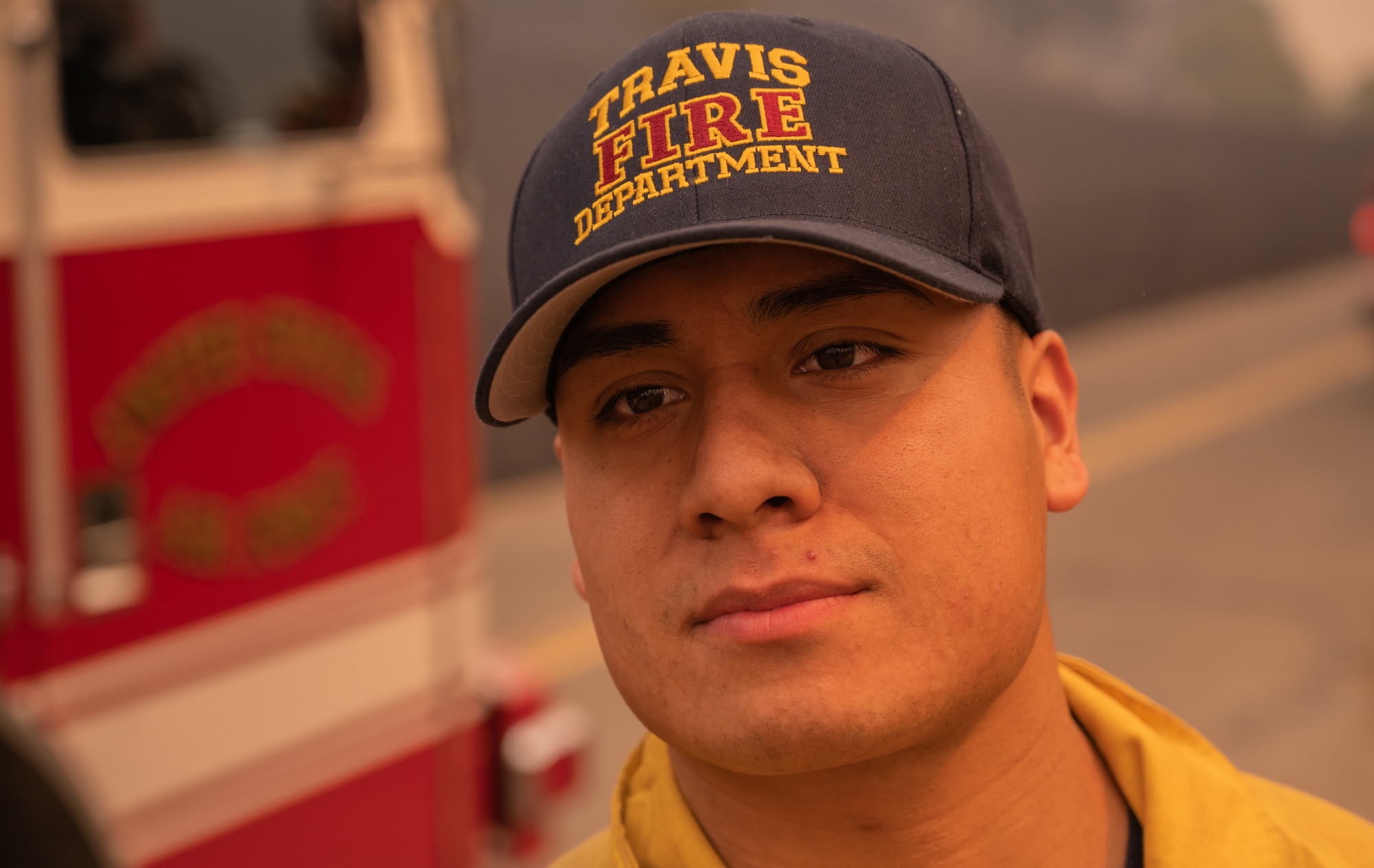 A firefighter looks past the camera.