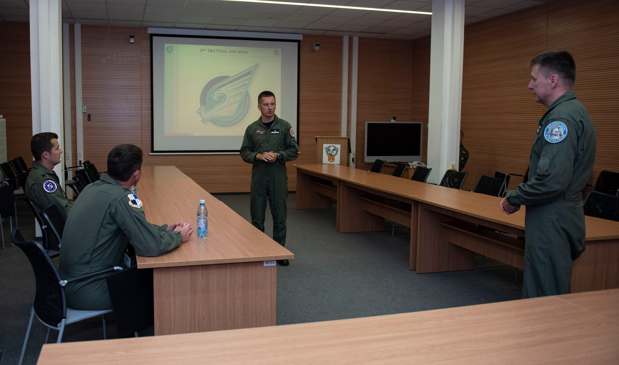 U.S. Air Force Col. David Epperson, left, 52nd Fighter Wing commander, and Lt. Col. Albert Roper, far left, 52nd Operations Group Detachment One commander, get a briefing by Polish Air Force Brig. Gen. Iteneusz Nowak, center, 2nd Tactical Air Wing commander, and Col. Tomasz Jatczak, right, 32nd Tactical Air Base commander, at Łask AB, Poland, August 21, 2020. Nowak and Jatczak discussed the 32nd Tactical AB mission and its capabilities to prepare resources for air operations in the national and allied system, along with providing logistic support for the units within areas of responsibility. (U.S. Air Force photo by Senior Airman Melody W. Howley)