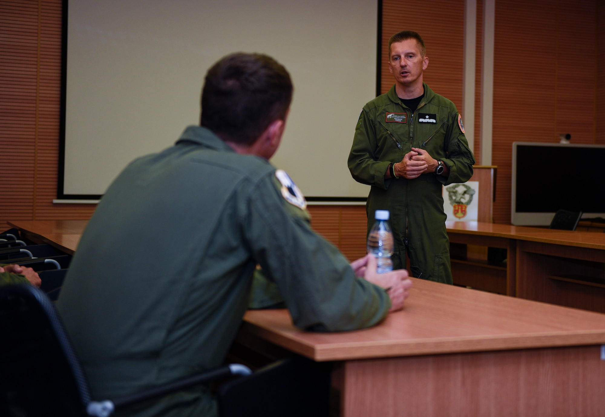 U.S. Air Force Col. David Epperson, front, 52nd Fighter Wing commander, listens to a briefing by Polish Air Force Brig. Gen. Iteneusz Nowak, 2nd Tactical Air Wing commander, at Łask AB, Poland, August 21, 2020. Nowak and Epperson were able to discuss different perspectives, the Aviation Detachment Rotation, and enhance the progress and partnerships between the U.S. and Polish Allies. (U.S. Air Force photo by Senior Airman Melody W. Howley)