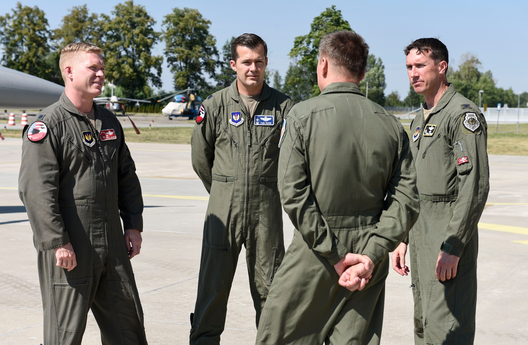 Polish Air Force Col. Tomasz Jatczak, front, 32nd Tactical Air Base commander, Lt. Col. Patrick Kennedy, far left, 480th Expeditionary Fighter Squadron commander, Lt. Col. Albert Roper, center, 52nd Operations Group Detachment One commander, and Col. David Epperson, far right, 52nd Fighter Wing commander, engage in conversation after media day at Łask AB, Poland, August 21, 2020. The United States presence in Poland allows the U.S. to respond to threats and support global operations and strengthens the NATO alliance overall. (U.S. Air Force photo by Senior Airman Melody W. Howley)