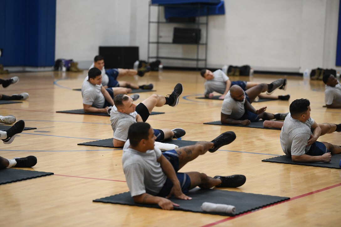 Airmen perform warm-up exercises during the Fly-Away Security Team training course, nicknamed “Pre-Raven,” at Joint Base Andrews, Md., Aug. 14, 2020.